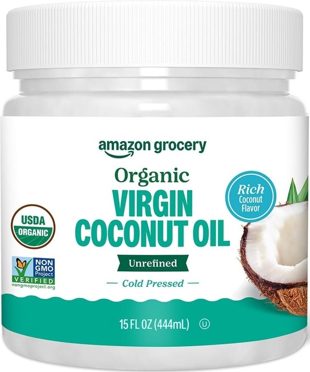 Close-up of organic virgin coconut oil in glass jar with creamy white oil visible through glass