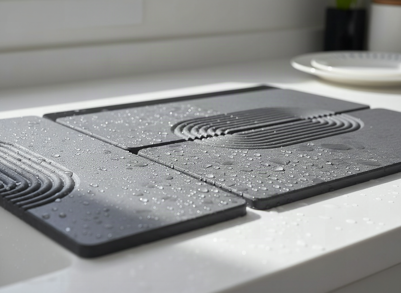 Close-up of curved grooves and water beads on dark gray stone drying mat surface
