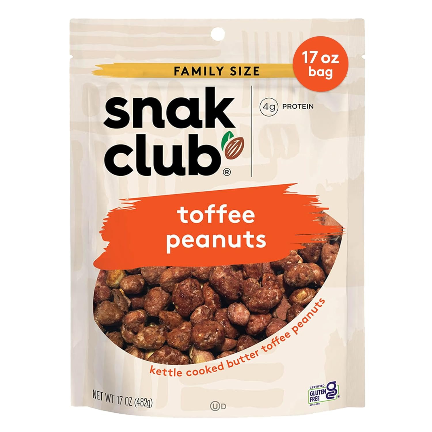 Snak Club toffee peanuts bag on a side table in a home setting with mug and book nearby