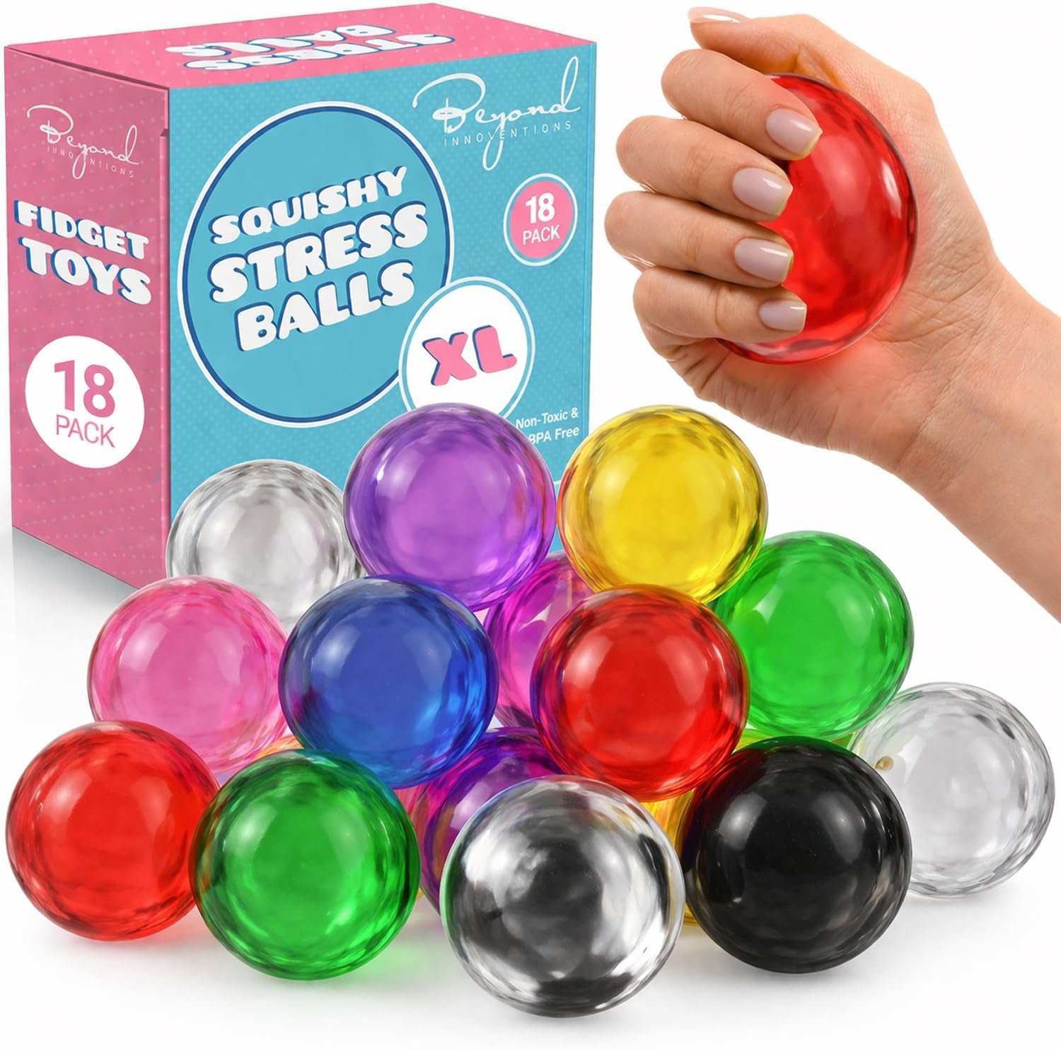 Stress balls displayed across a cluttered home office desk with laptop, mug, and workspace items in bright natural light