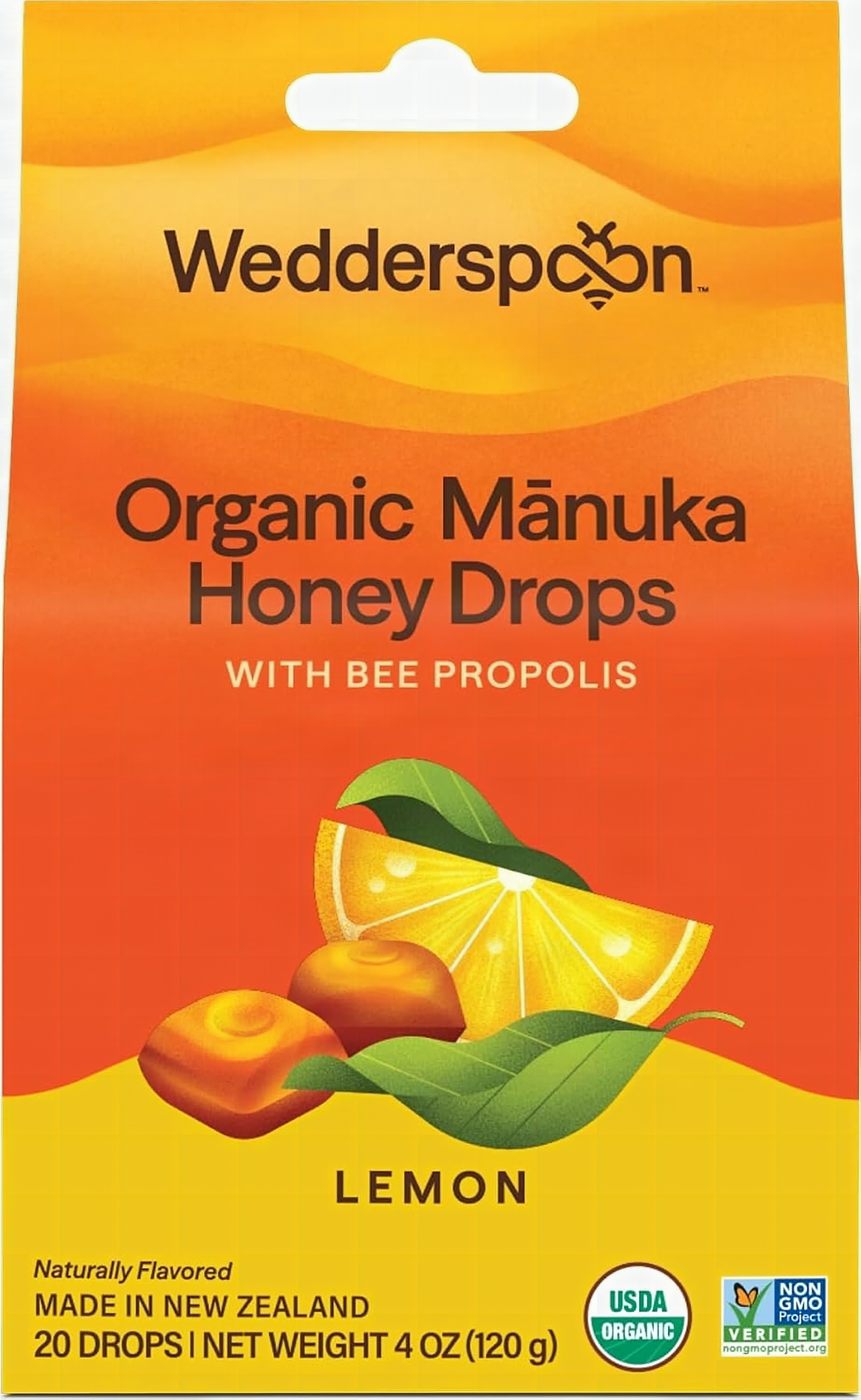 Macro close-up of a single golden Wedderspoon Manuka Honey Lemon drop with shallow focus and warm backlighting