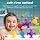 BUNMO suction toy among other bath toys arranged in and around a white bathtub filled with water