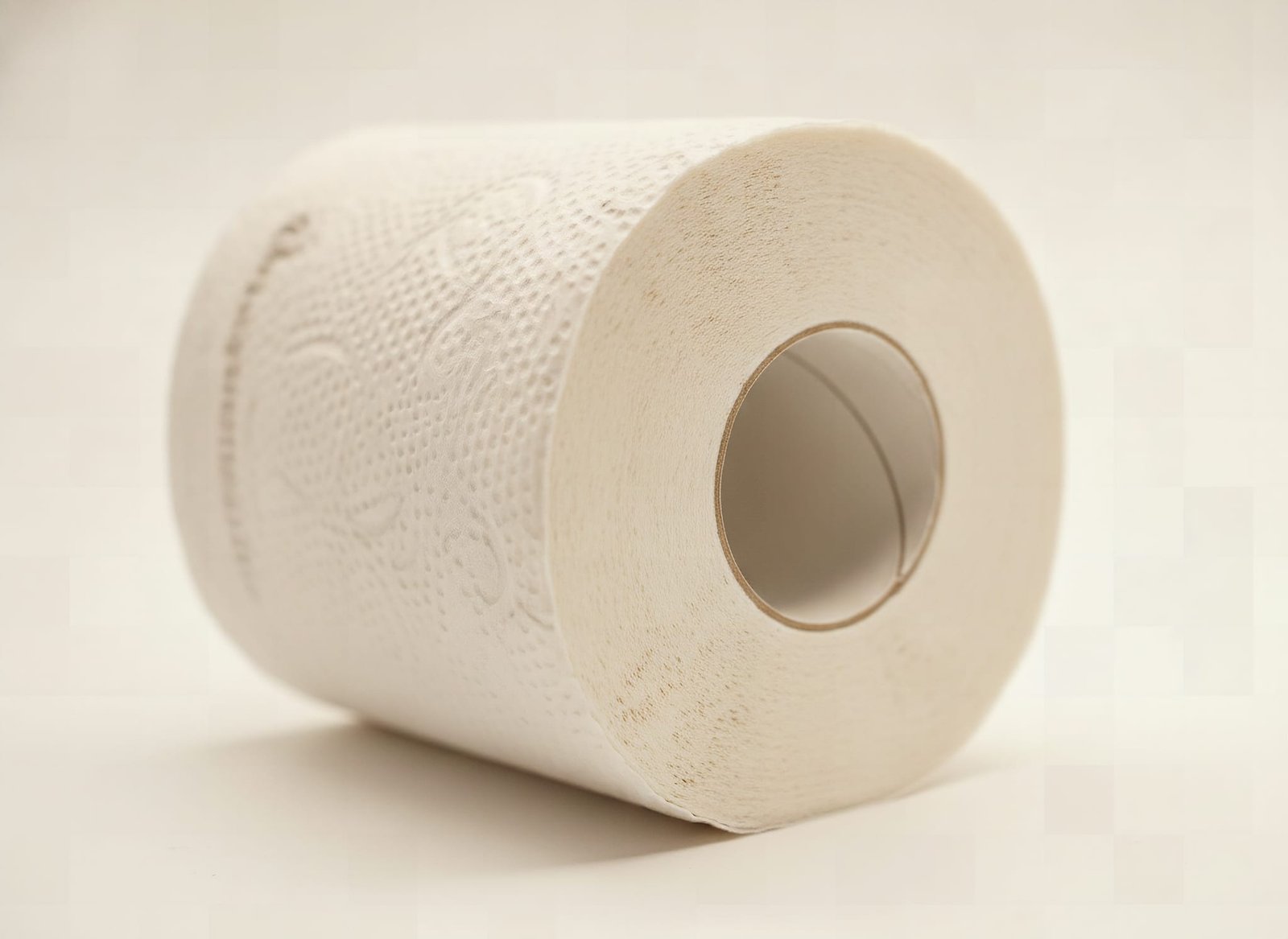 Macro close-up of Amazon Basics toilet paper showing soft 2-ply tissue texture and spiral layers