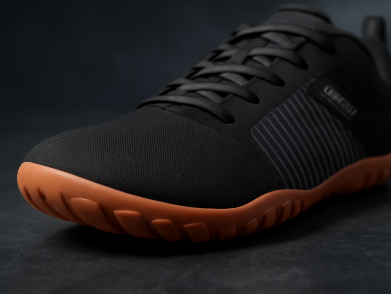 Macro close-up of WHITIN W51 wide trail shoe toe box and sole showing spacious toe spring design