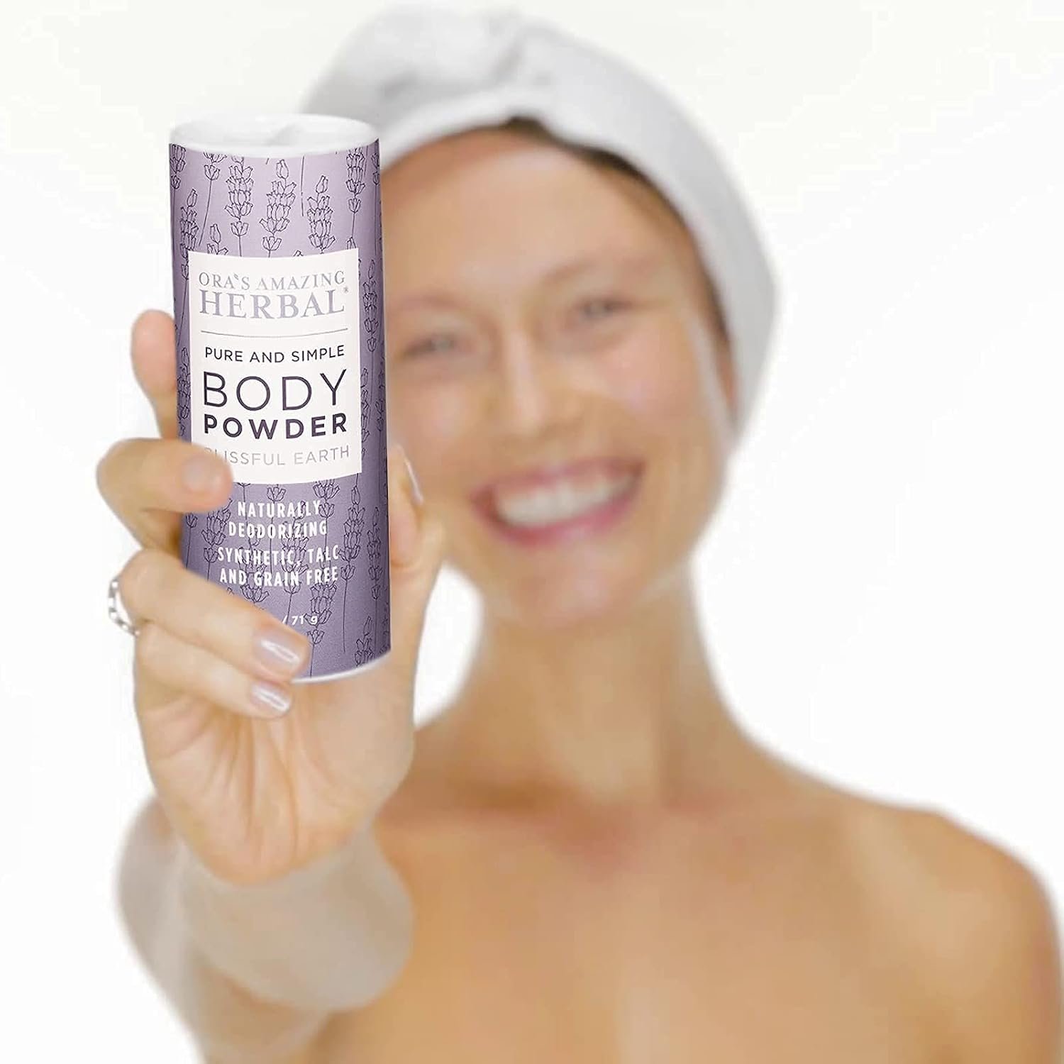 Talc-free body dusting powder on bathroom vanity counter with cotton rounds and oils nearby